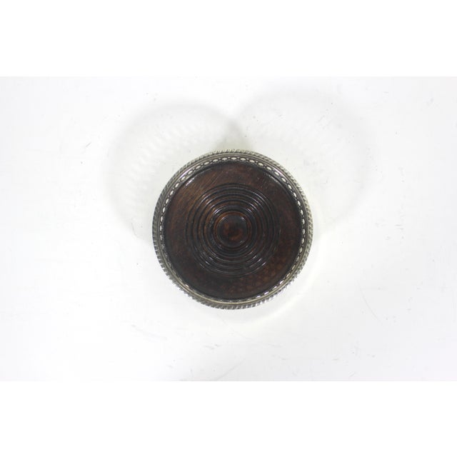 Vintage silver plated wine bottle coaster with wood base, pierced side detail. This has tarnish and patina. This fits a...