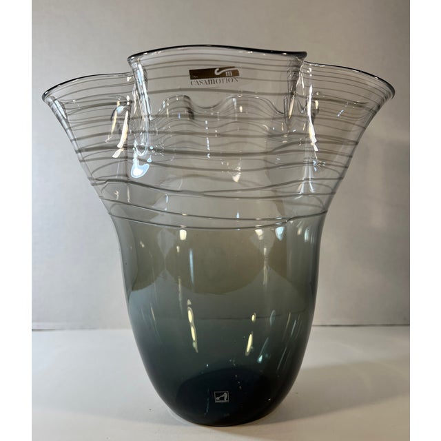 Admire the exquisite craftsmanship of this hand-blown art glass vase. Its design features an asymmetrical flared ruffled...
