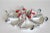 Set of six ceramic triangular hand painted rooster bowls. Several are marked "Italy" and numbered. Several chips noted and...