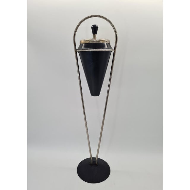 An elegant Mid-Century Modern standing ashtray from the 1960s/70s. Its minimalist, sculptural form is characteristic of...