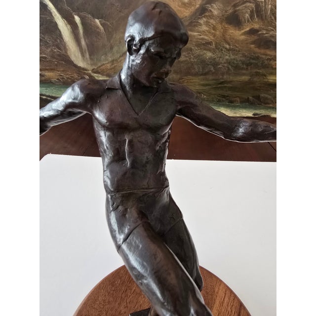 A very fine limited edition signed and dated mid century modern bronze sculpture of a footballer . Having a museum quality...