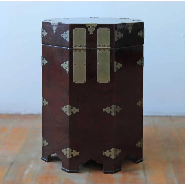 Pair of petite antique mahogany octagonal side tables with brass fittings and front locks. The brass locks are cast and...