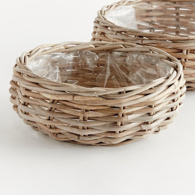 Woven by hand in a thick Kubu rattan that is claydyed & dried in the sun, these sturdy low basket planters are the epitome...