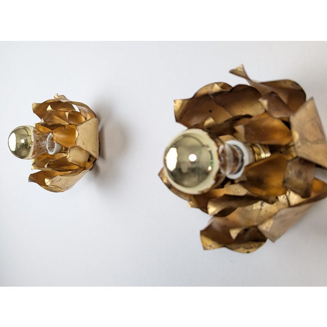Pair of Hans Kogl wall sconces in gold-plated metal, designed in his signature open flower shape. Each piece features...