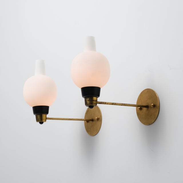 Pair of italian wall sconces dating from the 1950s, featuring a refined mid-century modern design with a clean horizontal...