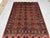 Bring warm color and rhythmic pattern to your home with this red wool area rug featuring a Turkmen Philpa tribal design....