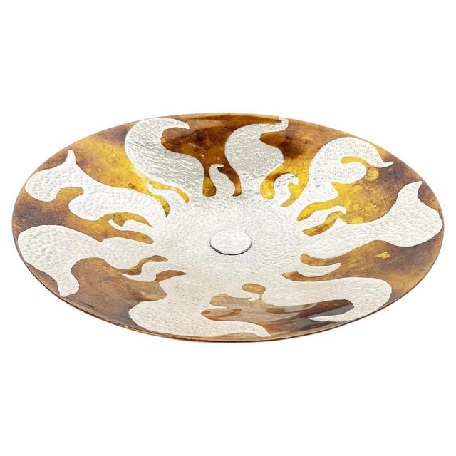 Large decorative catchall dating from the 1970s, featuring a shallow circular form with a warm brown and amber-toned...