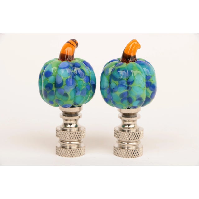 Pair of lamp finials crafted from speckled glass pumpkins mounted on knurled chrome finial bases sized to fit a standard-...