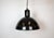 Industrial factory hanging lamp made in former Czechoslovakia during the 1950s. It features a black enamel shade with...