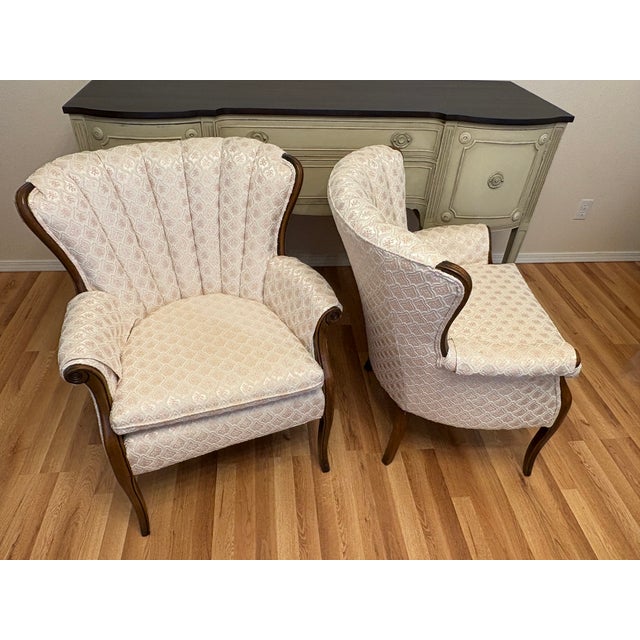 They are reproduction of the French Louis XV Upholstered Lounge Chairs, a pair. Channel tufing in the back of the chairs...