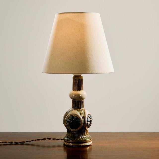 A Danish ceramic table lamp from the 1970s. The lamp has organic patterns and a glossy glaze. In nice condition with a new...