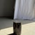 Small side table in black petrified wood with beige streaks on the gray side. Petrified wood is a fossilized wood (from...