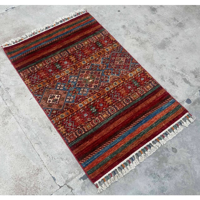 Bring rich character and artisanal craftsmanship into your space with this vintage tribal kilim rug, handwoven from 100%...
