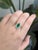 A standout statement with heirloom soul. Centered by a vivid GIA-certified 1.18 ct Colombian emerald, this ring is wrapped...