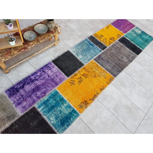 This is a vintage Turkish Oushak rug from the Mid 20th Century. The piece was hand-knotted.