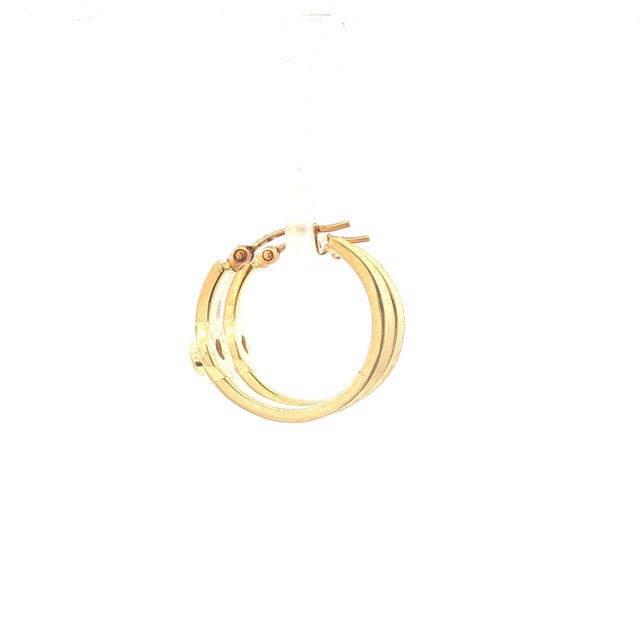 A pair of 14k gold hoop earrings featuring round white diamond accents. Each earring showcases a single diamond set into...