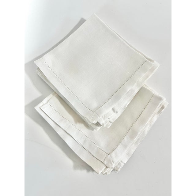 A set of 12 vintage white cotton luncheon napkins featuring simple hemstitched borders and a soft, lightweight hand. Their...