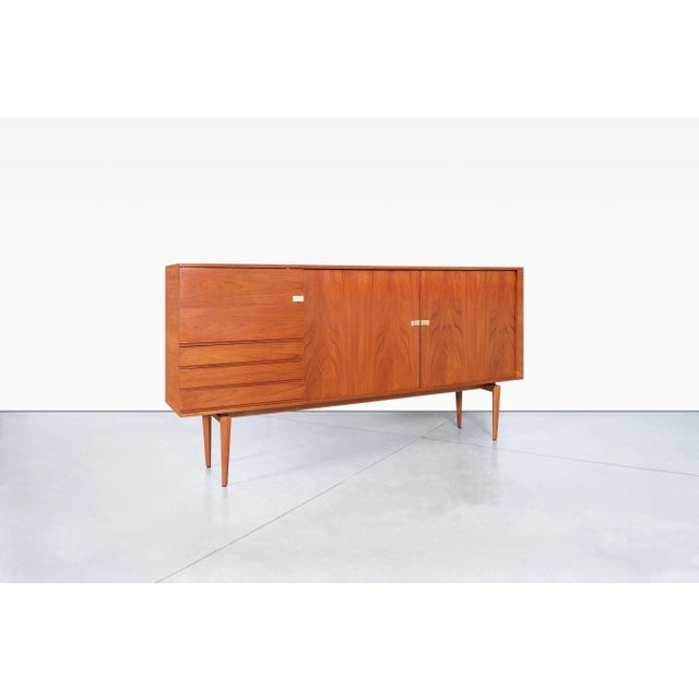 Danish Modern teak credenza designed by H.W. Klein and masterfully crafted by Bramin, Denmark, circa 1960s. This...