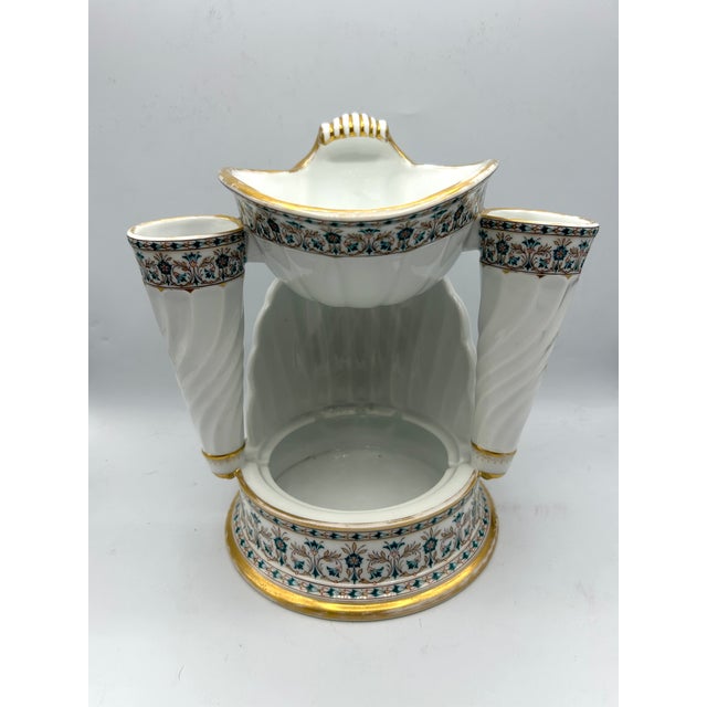 An unusual late Victorian English porcelain washstand organizer featuring a shell-form soap dish, lower sponge tray, and...