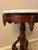 This walnut accent table with a beautiful Victorian style three legged base has a round white marble top which is...