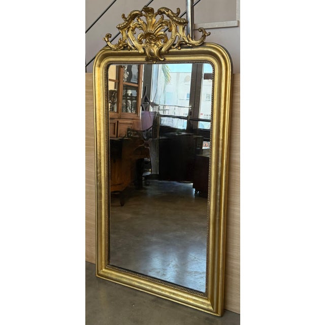 An exceptional large scale mirror hand-crafted in France, this piece is vertical symmetrical and the original mirror plate...