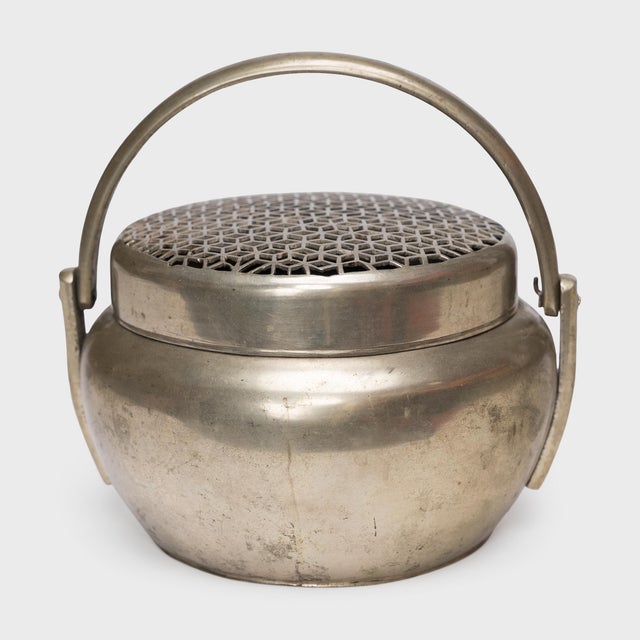 Filled with burning coals, this 19th-century brass brazier once warmed the hands of a well-to-do person on a cold winter's...