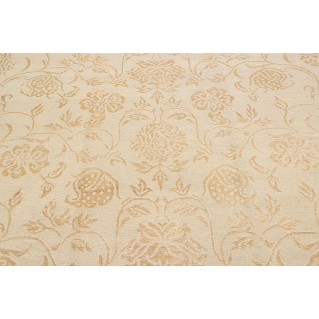 Crafted from premium quality wool and silk, this contemporary Nepalese rug features an intricate all-over scroll floral...
