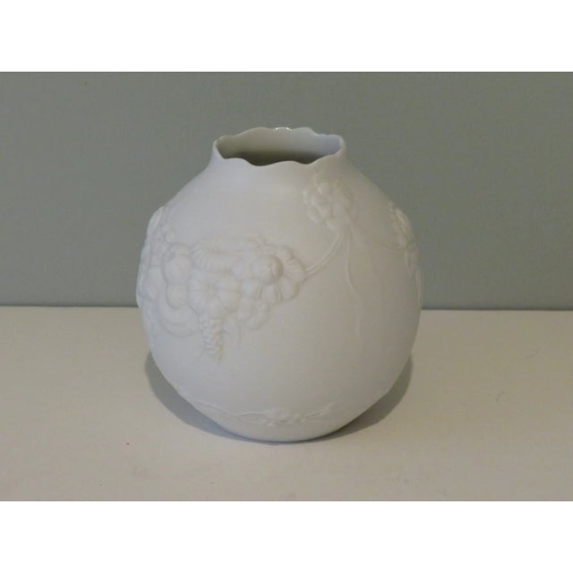 Beautiful convex vase made of very fine biscuit porcelain with floral motif. The outside of the vase is matte and the...