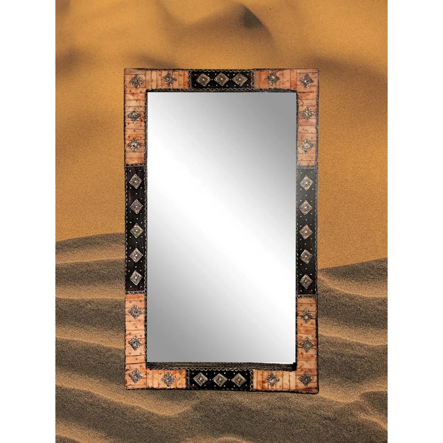 Large eye catching rectangular wall mirror from Morocco. Hand made with cut and hammered silver alloy metal embellishments...