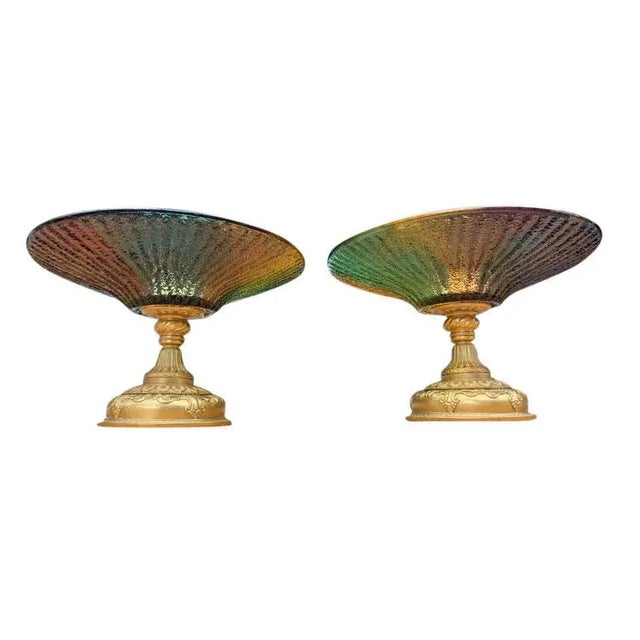 A pair of stunning and large color glass tazze, with gold gilded bases, 20th century. A tazza (italian, "cup", plural...