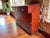 Stained a deep brick red with aniline dye and then varnished. The expected wear and character for a piece that would have...