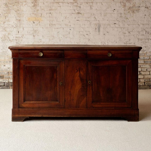 This exceptional 19th century French Louis Philippe walnut buffet is a striking example of mid-1800s French provincial...