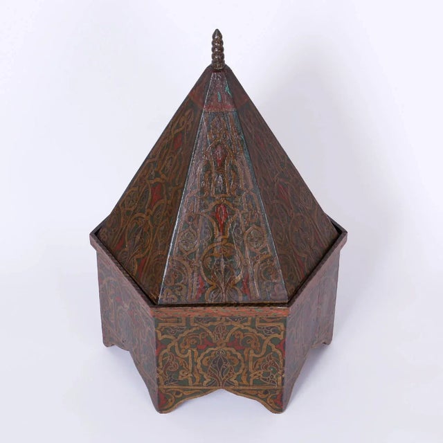 Antique Moroccan wood box painted on all six sides with symbolic floral designs over an architecturally intriguing form...
