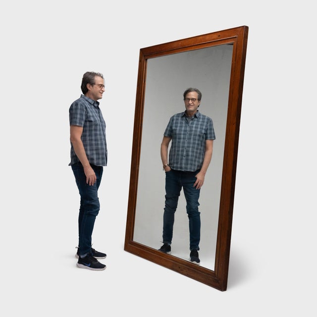 Large enough to fill a wall, this monumental antique mirror makes a statement with its impressive scale and beautiful...