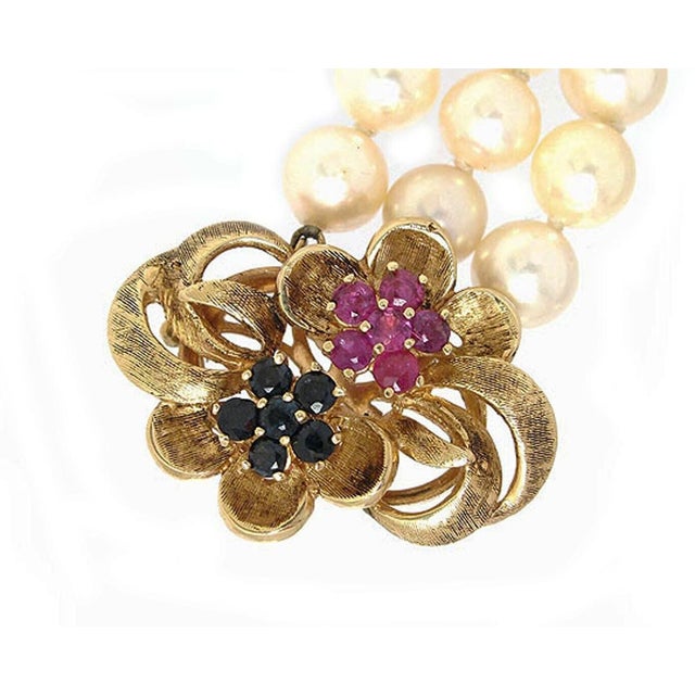This beautiful estate bracelet features three strands of lustrous 7 mm pearls, finished with a lovely textured floral...
