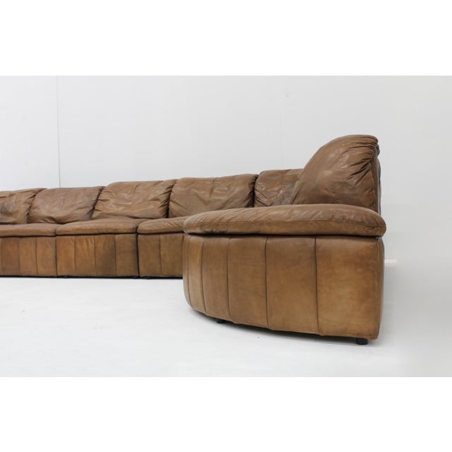 Vintage Brown Leather modular sectional lounge sofa from the 70s designed by the brand Laauser. Large corner sofa with 7...