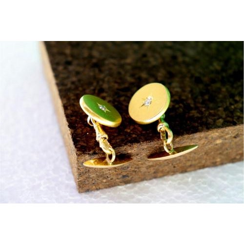 Gold cufflinks in the shape of a button with star-shaped cutouts for brilliant-cut diamonds in the center. Metal: Gold....