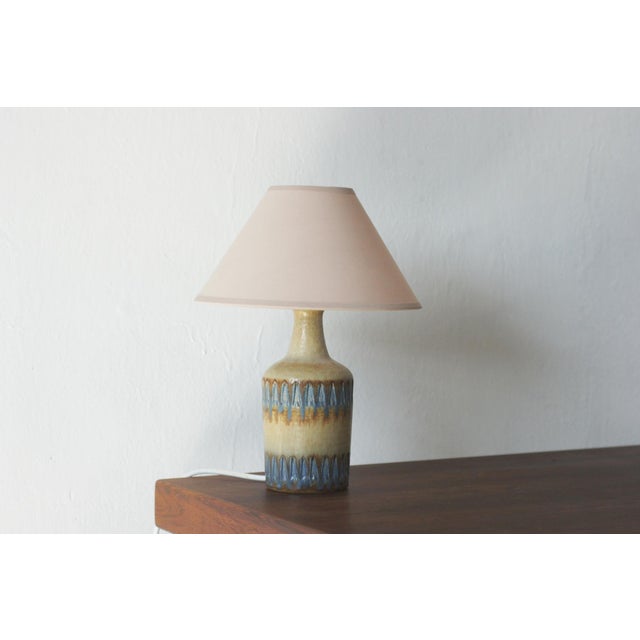 An elegant ceramic table lamp in the spirit of Scandinavian modernism, produced by the Danish manufacturer Søholm...