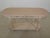 Grapevine carved 2 drawer white decorated console table. Features dovetailed drawer construction, grapevine carved legs...