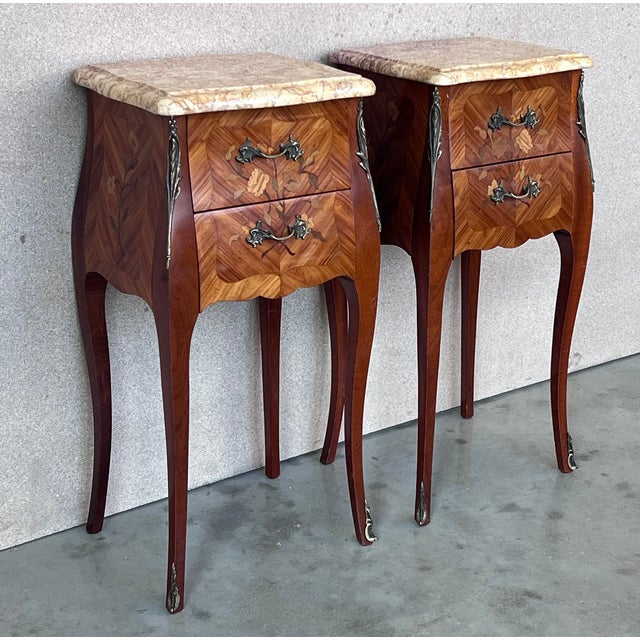 About the Item A pair of Antique French Louis XV Marquetry marble top nightstands. Subtle contours and scroll shapes are...
