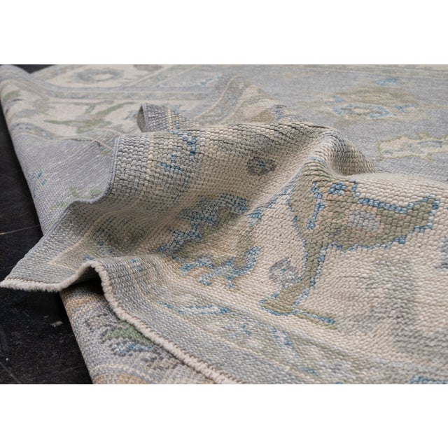 Turkish Oushak Rug Soft Blue & Beige Floral Handwoven Wool Rug 6'4" X 9'1" This handwoven Turkish Oushak rug features a...