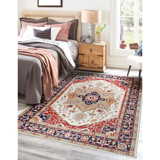 A hand-knotted wool rug, made in India and measuring 8' x 10'. Floral drawing carried across the field inside a...