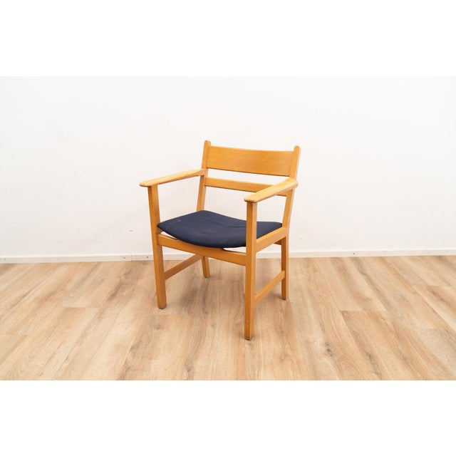 Set of four Armchairs by Hans J. Wegner for Getama. The chairs come with a blue fabric upholstery on the seating and...