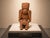 A vintage terracotta seated figure sculpture executed in a Pre-Columbian-inspired style, featuring a tall ceremonial...