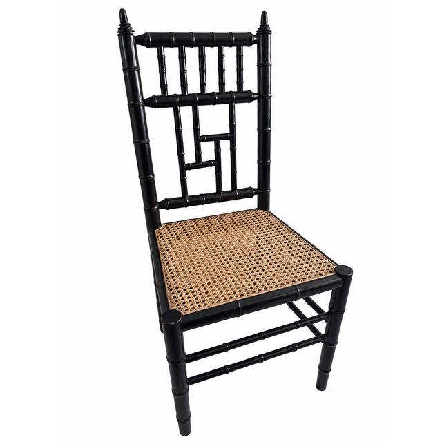 Elegant late 20th century faux bamboo accent chair featuring a satin black finish and beautifully preserved natural woven...