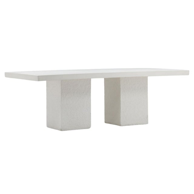 Modern cream/white concrete outdoor dining table. Smooth finish top with plaster textured finish cubed legs. Weighs...