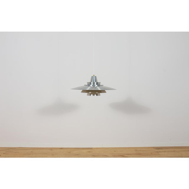 This large pendant lamp was designed by Mogens Davidsen for the Danish lighting manufacturer Superlight during the 1970s....