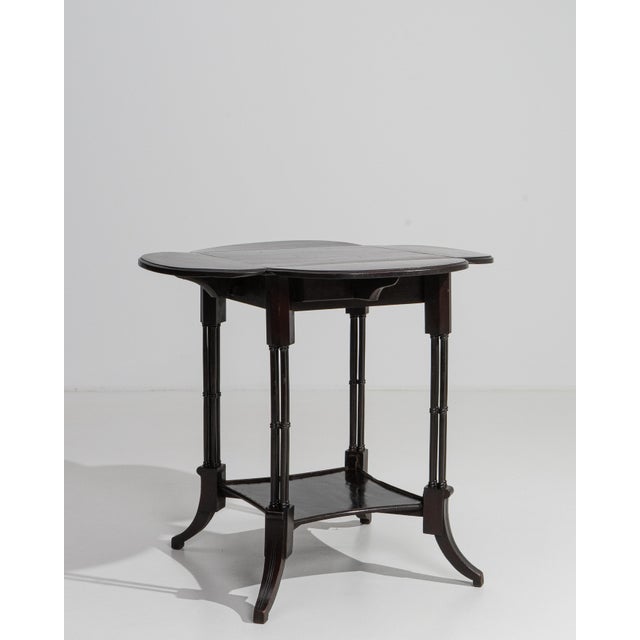 A masterwork of restrained Edwardian elegance, this rare four-flap table from the United Kingdom exemplifies the refined...