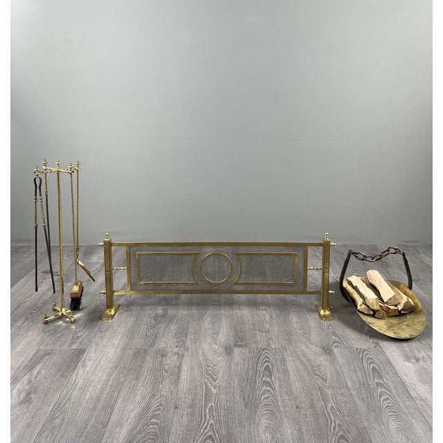 Beautiful brass fireplace set comprising a fire screen with grate, a fireplace tool set (shovel, tongs, poker, brush), and...