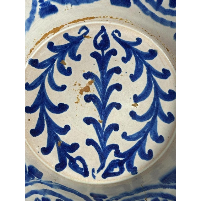 This hand-thrown faience bowl exemplifies the rustic charm of traditional Fajalauza ceramics, a craft dating back to the...